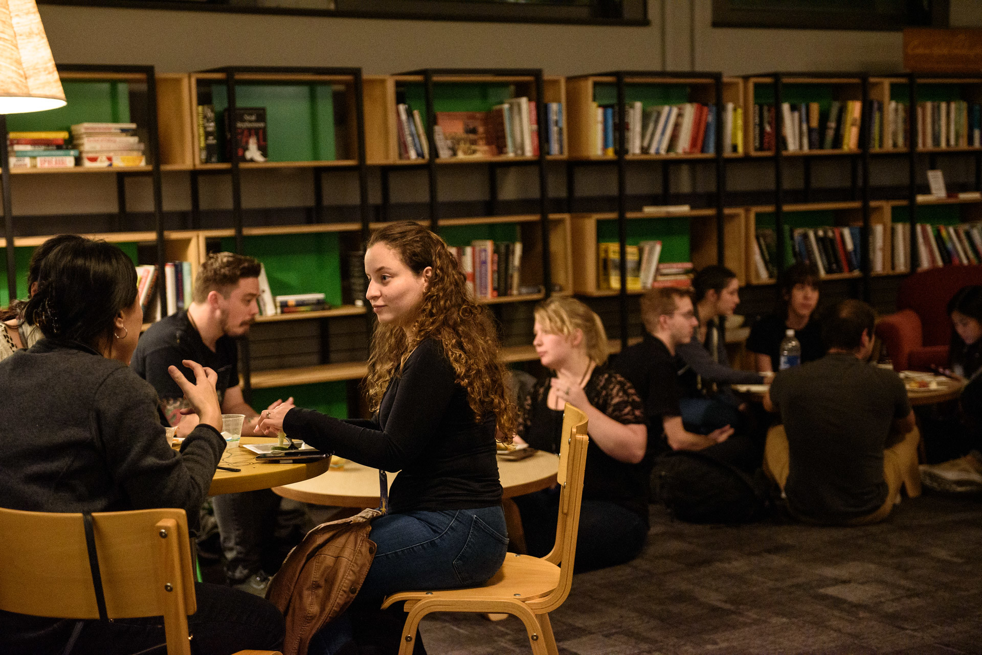 Folks sitting down and talking at an evening event